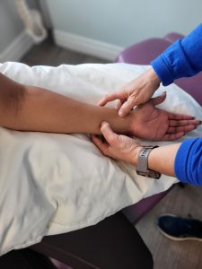active release being performed on a patients wrist for carpal tunnel injury