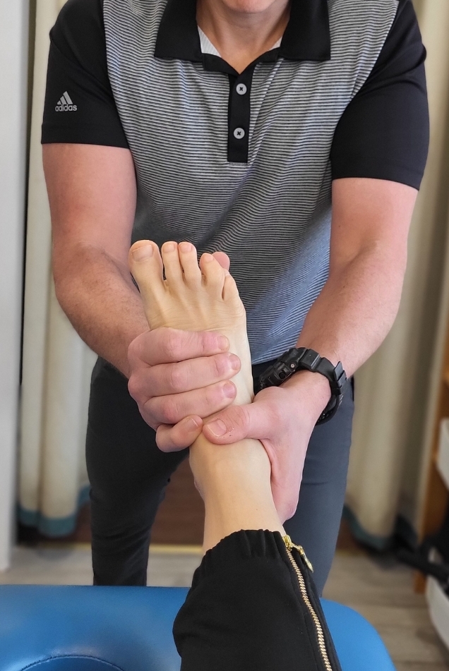 Dr. Steve doing ankle adjustments on patient 