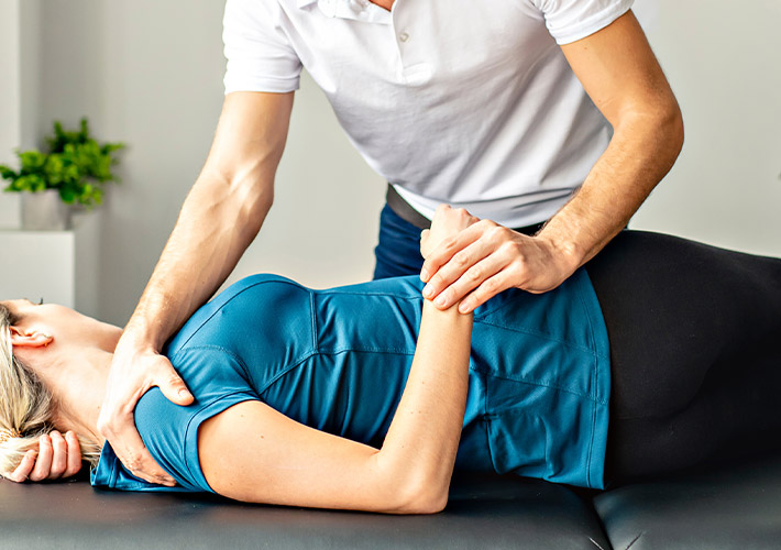 A chiropractor treating patient for back pain