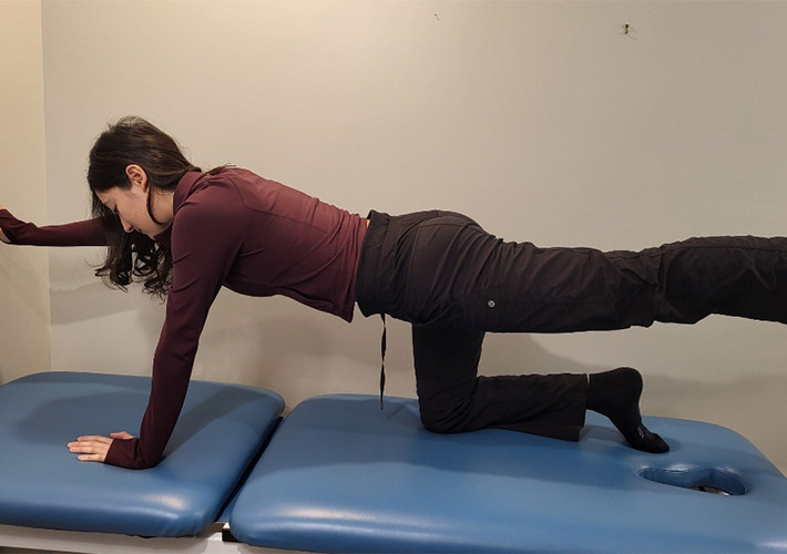 A team member from Oakville Clinic showing exercise for back pain