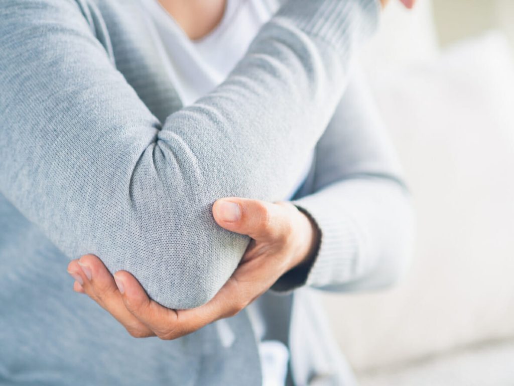 Closeup female's elbow. Arm pain and injury.