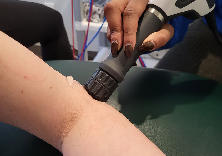 A patient receiving shockwave treatment for golfer's elbow