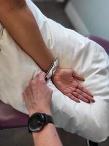 graston tool being used like on a patients wrist
