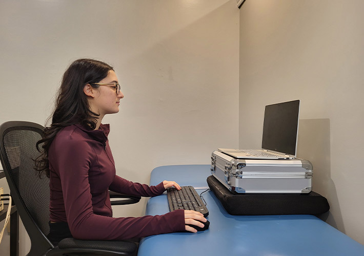 A team member from the Oakville Clinic showing correct way to setup laptop 