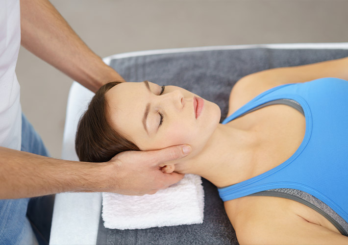 A female patient receiving massage therapy for neck pain