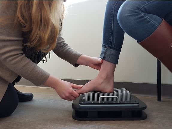 A doctor taking measurements for Custom Orthotics