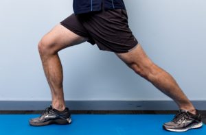 a person stretching their calve in a lunge type position