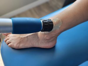 shockwave therapy on the outside of a patients ankle
